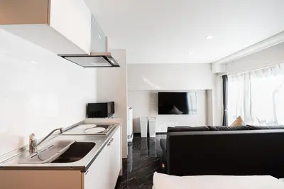 a kitchen and living room with a sink and a couch at saiei hotel 502 in Tokyo