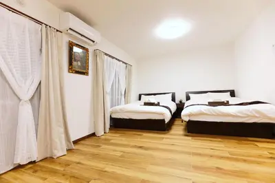 two beds in a room with wooden floors at Okubo 106-SJ0020 in Tokyo
