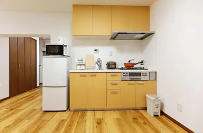 a kitchen with yellow and white appliances and wooden floors at Okubo 106-SJ0020 in Tokyo