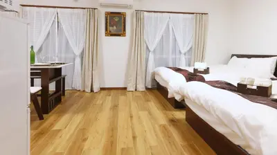 a bedroom with two beds and a table and a desk at Okubo 106-SJ0020 in Tokyo