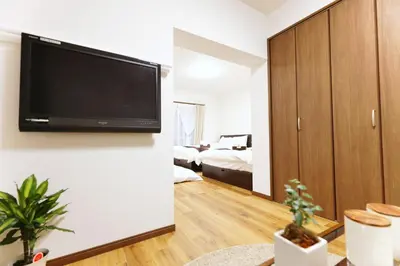 a living room with a flat screen tv on a wall at Okubo 106-SJ0020 in Tokyo