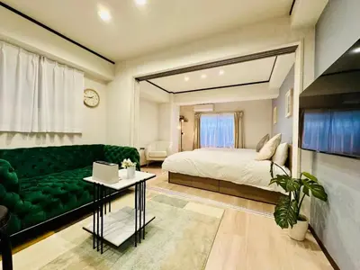 a living room with a bed and a couch at Yochomachi Hostel\u82e5\u677eSJ0357 in Tokyo