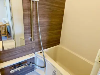 a bathroom with a tub and a shower at Yochomachi Hostel\u82e5\u677eSJ0357 in Tokyo