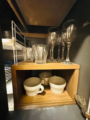 a wooden shelf with glasses and bowls on it at Oji House-KI0022 in Tokyo