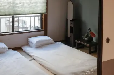 two beds in a room with a window at Oji House-KI0022 in Tokyo