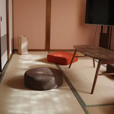 a living room with two ottomans and a table at Oji House-KI0022 in Tokyo