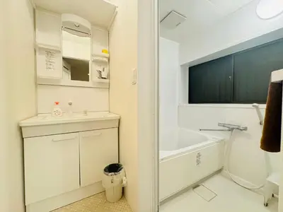 a white bathroom with a sink and a bath tub at Oji House-KI0022 in Tokyo