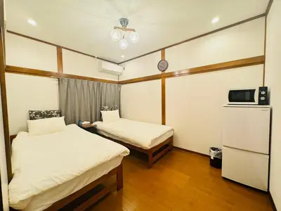 a small room with two beds and a tv at Oji House-KI0022 in Tokyo