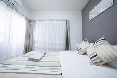 a bedroom with a bed with two pillows and a window at First Look House-SM0028 in Tokyo