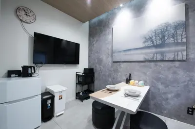 a room with a table and a tv on a wall at First Look House-SM0028 in Tokyo
