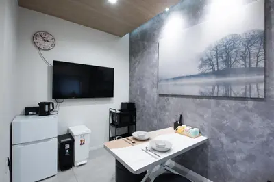 a room with a table and a tv and a refrigerator at First Look House-SM0028 in Tokyo