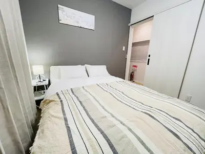 a bedroom with a bed and a desk in it at First Look House-SM0028 in Tokyo