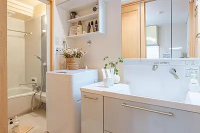 a white bathroom with a toilet and a sink at Near Skytree 6-minute walk from Keisei Tokifune, direct access to Airport in Tokyo