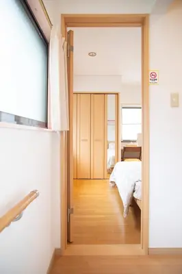 a bedroom with a door leading to a bed at Near Skytree 6-minute walk from Keisei Tokifune, direct access to Airport in Tokyo