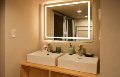a bathroom with a white sink and a mirror at 5 minutes on foot from tokyo Asakusa Station!A beautiful house that has been fully renovated in 2024 for one group per day\u6771\u4eac\u96f7\u9580\u304b\u3089\u5f92\u6b694\u52061\u65e51\u7d44\u9650\u5b9a\u8cb8\u52072024\u5e74\u5168\u9762\u30ea\u30d5\u30a9\u30fc\u30e0\u6e08\u307f\u306e\u7dba\u9e97\u306a\u4e00\u8ed2\u5bb6 in Tokyo