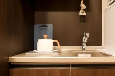 a kitchen sink with a tea pot on it at 5 minutes on foot from tokyo Asakusa Station!A beautiful house that has been fully renovated in 2024 for one group per day\u6771\u4eac\u96f7\u9580\u304b\u3089\u5f92\u6b694\u52061\u65e51\u7d44\u9650\u5b9a\u8cb8\u52072024\u5e74\u5168\u9762\u30ea\u30d5\u30a9\u30fc\u30e0\u6e08\u307f\u306e\u7dba\u9e97\u306a\u4e00\u8ed2\u5bb6 in Tokyo