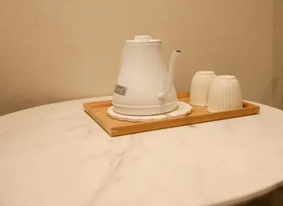 a tea kettle and two white cups on a wooden tray at 5 minutes on foot from tokyo Asakusa Station!A beautiful house that has been fully renovated in 2024 for one group per day\u6771\u4eac\u96f7\u9580\u304b\u3089\u5f92\u6b694\u52061\u65e51\u7d44\u9650\u5b9a\u8cb8\u52072024\u5e74\u5168\u9762\u30ea\u30d5\u30a9\u30fc\u30e0\u6e08\u307f\u306e\u7dba\u9e97\u306a\u4e00\u8ed2\u5bb6 in Tokyo