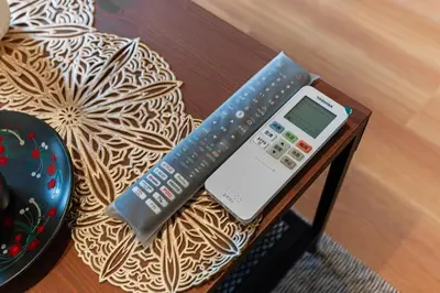 a table with a remote control and a calculator on it at saiei hotel 201 in Tokyo