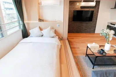 a bedroom with a bed and a table with a tv at saiei hotel 201 in Tokyo