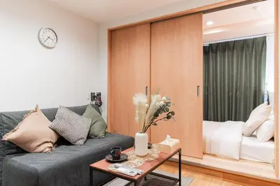 a living room with a couch and a table at saiei hotel 201 in Tokyo