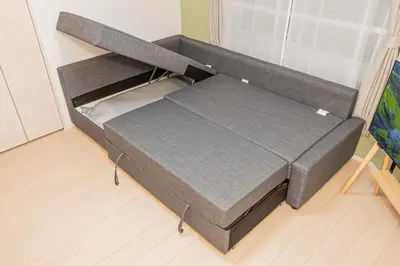 a small bed in a room with a bed frame at Float Inn Shin-Okachimachi in Tokyo