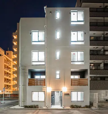 a white building with lights on the side of it at Float Inn Shin-Okachimachi in Tokyo