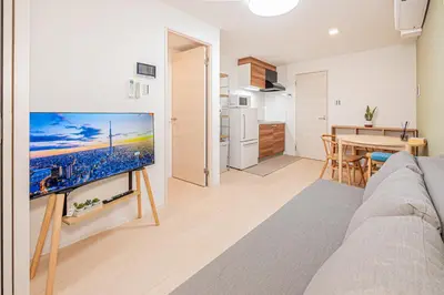 a living room with a large flat screen tv at Float Inn Shin-Okachimachi in Tokyo