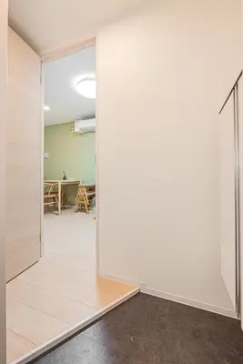 an open door into a room with a table at Float Inn Shin-Okachimachi in Tokyo