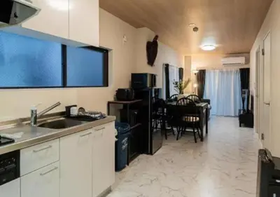 a kitchen with a sink and a dining room at Kasai Light Luxury House 101 in Tokyo