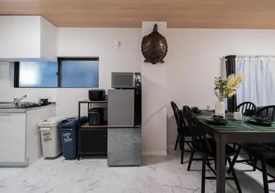 a kitchen and dining room with a table and a refrigerator at Kasai Light Luxury House 101 in Tokyo