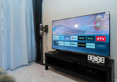 a flat screen tv sitting on a stand in a living room at Kasai Light Luxury House 101 in Tokyo