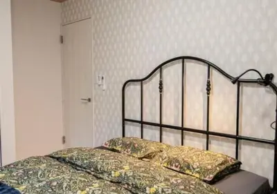 a bed with a metal head board in a bedroom at Kasai Light Luxury House 101 in Tokyo