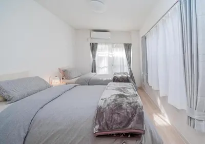 a bedroom with two beds and a large window at Kasai Light Luxury Hotel 201 in Tokyo