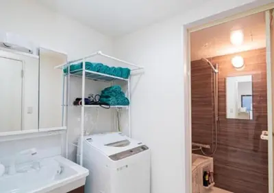 a white bathroom with a sink and a washing machine at Kasai Light Luxury Hotel 201 in Tokyo