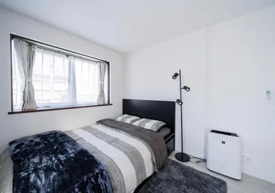 a bedroom with a bed and a large window at Kasai Light Luxury Hotel 301 in Tokyo