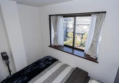 a bedroom with a bed and a window at Kasai Light Luxury Hotel 301 in Tokyo