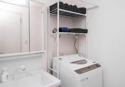 a laundry room with a washing machine and a sink at Kasai Light Luxury Hotel 301 in Tokyo