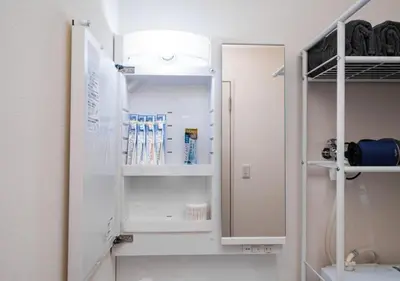 a bathroom with a white refrigerator with its door open at Kasai Light Luxury Hotel 301 in Tokyo