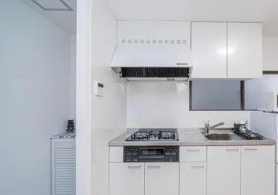 a white kitchen with white cabinets and a sink at Kasai Light Luxury Hotel 301 in Tokyo