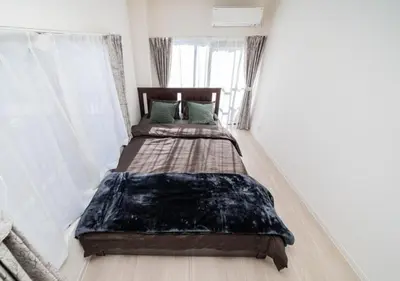 a bedroom with two beds in a room at Kasai Light Luxury Hotel 301 in Tokyo