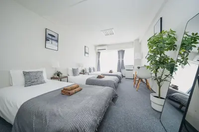 a bedroom with two beds and a living room at 4 minutes walk from Shibuya Station 3 beds in Tokyo