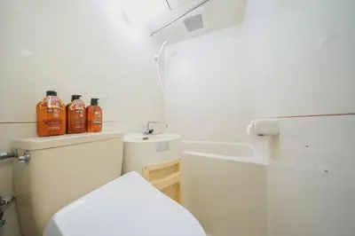 a small bathroom with a toilet and a sink at 4 minutes walk from Shibuya Station 3 beds in Tokyo
