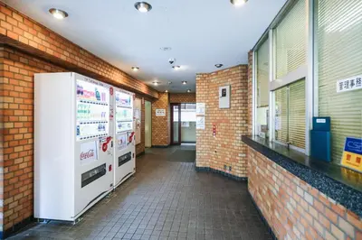 a room with two refrigerators and a brick wall at 4 minutes walk from Shibuya Station 3 beds in Tokyo