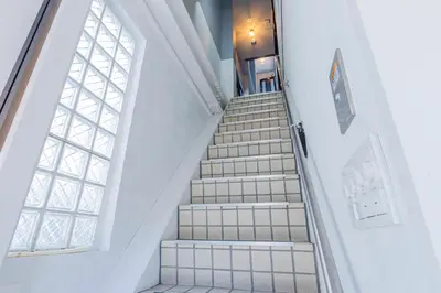 a staircase in a building with a window at \u3077\u3075\u304b\u30bf\u30de\u30ce\u30a4-Pufuka Tamanoi in Tokyo