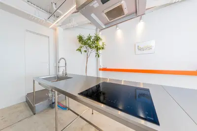 a kitchen with a stainless steel counter top and a sink at \u3077\u3075\u304b\u30bf\u30de\u30ce\u30a4-Pufuka Tamanoi in Tokyo
