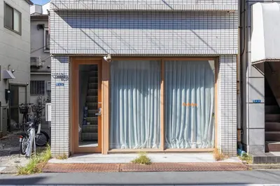 a large glass door of a building with a bicycle in front at \u3077\u3075\u304b\u30bf\u30de\u30ce\u30a4-Pufuka Tamanoi in Tokyo