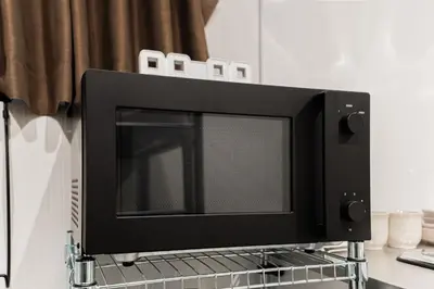 a microwave oven sitting on top of a rack at saiei hotel 202 in Tokyo