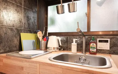 a kitchen counter with a sink and a mirror at The Villa Ebisu BLUE\u60e0\u6bd4\u5bff\u99c5\u5f92\u6b658\u5206 \u9759\u304b\u306a\u4f4f\u5b85\u5730 in Tokyo