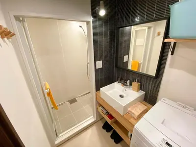 a bathroom with a sink and a shower with a mirror at The Villa Ebisu BLUE\u60e0\u6bd4\u5bff\u99c5\u5f92\u6b658\u5206 \u9759\u304b\u306a\u4f4f\u5b85\u5730 in Tokyo