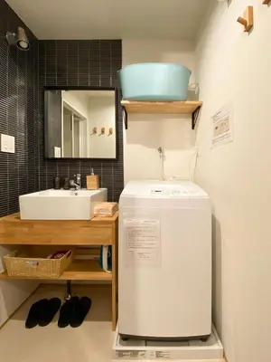 a small bathroom with a sink and a refrigerator at The Villa Ebisu BLUE\u60e0\u6bd4\u5bff\u99c5\u5f92\u6b658\u5206 \u9759\u304b\u306a\u4f4f\u5b85\u5730 in Tokyo